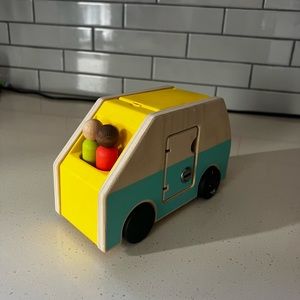 Lovevery camper van and two wooden peg people